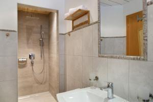 a bathroom with a sink and a shower at Zillertalblick in Zellberg +27 photos