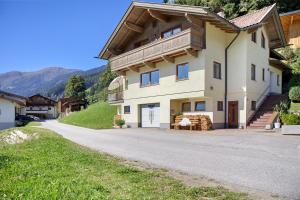 a large house on a hill with a driveway at Zillertalblick in Zellberg