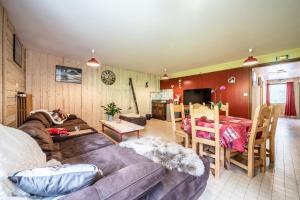 a living room with a couch and a table at Coeur de Charmy Spa bien-être in Abondance