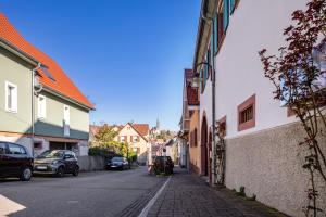 a city street with buildings and cars parked on the street at Fewo Schmidt in Bahlingen