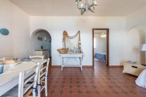 a kitchen with white walls and a table at Casa Nicoleup in Porto Columbu - Perdʼe Sali