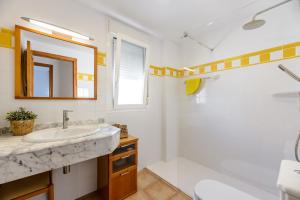 a bathroom with a sink and a tub and a mirror at Edificio can Sord Apto nº 2 in La Savina +26 photos