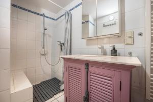 a bathroom with a pink cabinet and a shower at Alte Polsterei in Nienstädt +12 photos