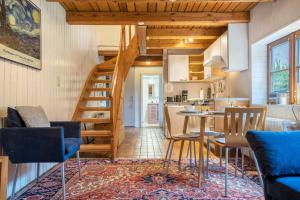 a kitchen and dining room with a spiral staircase in a house at Alte Polsterei in Nienstädt