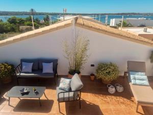 a balcony with chairs and a table with a view of the ocean at Edificio can Sord Apto nº 2 in La Savina