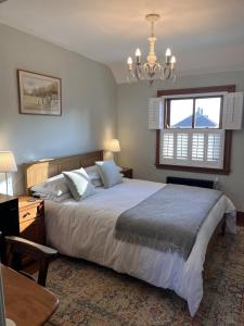 a bedroom with a large bed and a window at The Globe House in Broseley