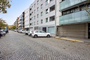 a row of cars parked in front of a building at Mary House in Matosinhos