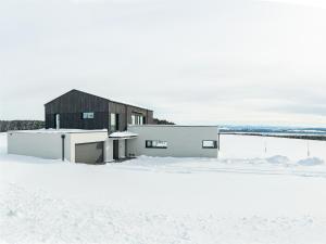 a house in the snow in front at Chalet Am Ried in Bad Wurzach