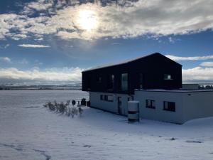 a black and white building in the snow at Chalet Am Ried in Bad Wurzach