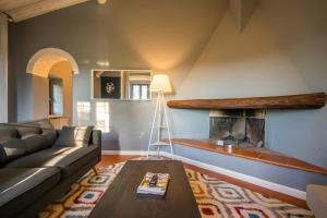a living room with a couch and a fireplace at Villa Assolata in Pietraviva