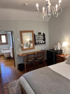 a bedroom with a bed and a bathroom with a mirror at The Globe House in Broseley +14 photos