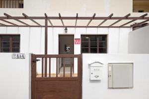 a wooden door in front of a white building at Casa Candido in Playa Honda