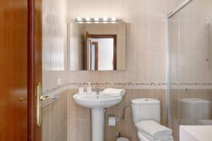 a bathroom with a sink and a toilet and a mirror at Casa Candido in Playa Honda +12 photos