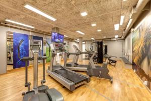 a gym with treadmills and elliptical machines at Scandic Linköping Väst in Linköping