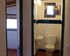 a bathroom with a toilet and a sink at Granados in Fuenteheridos +12 photos