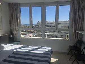 a bedroom with a bed and a large window at Loft Molinos Atalaya in San Bartolomé
