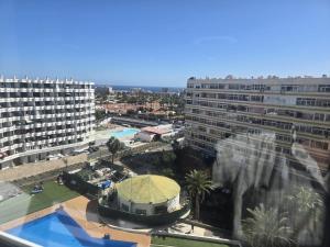 a view of a city with a building and a pool at Loft Molinos Atalaya in San Bartolomé +6 photos