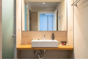 a bathroom with a white sink and a mirror at Joy Horizon in Skala +12 photos