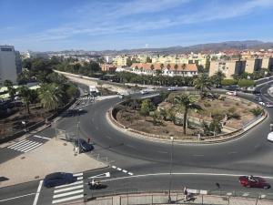 a winding road in a city with buildings and palm trees at Loft Molinos Atalaya in San Bartolomé