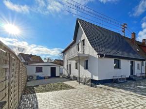a white house with a black roof at Ferienwohnung Hochwangen in Ichenhausen