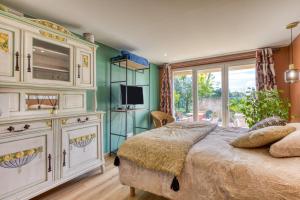 a bedroom with a large bed and a window at Aux Amelierets in Saint-Just