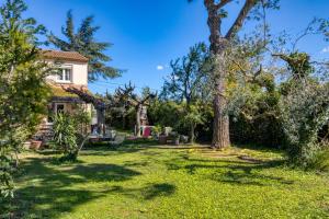 a yard with trees and a house at Aux Amelierets in Saint-Just