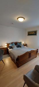 a bedroom with a large wooden bed with blue pillows at Fremdenzimmer Familie Förster in Villingen-Schwenningen