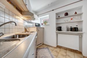 a kitchen with a sink and a counter at Ferienwohnung Malia in Neubulach +12 photos
