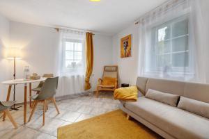 a living room with a couch and a table at Ferienwohnung Malia in Neubulach