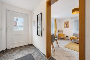 a hallway with a door and a living room at Ferienwohnung Malia in Neubulach