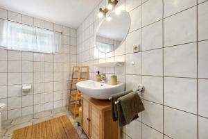 a bathroom with a sink and a mirror at Ferienwohnung Malia in Neubulach
