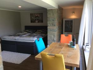 a bedroom with a bed and a table and chairs at Ferienhaus Dell in Möhnesee