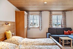 a living room with a bed and a couch at Ferienwohnung Lengdobler - Leni in Bad Kohlgrub