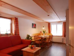 a living room with a couch and a table at Haus Trötschler in Weilheim