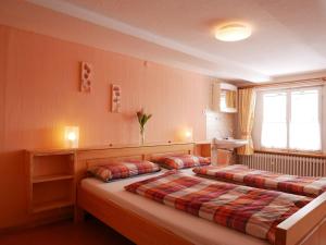 a bedroom with two beds and a window at Haus Trötschler in Weilheim