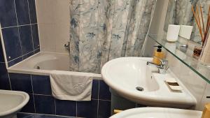 a bathroom with a sink and a toilet and a tub at Apartment Laguna 70 in Izola