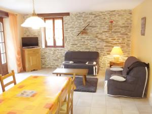 a living room with a couch and a table at Gite Belcastel -Village d’Exception in Belcastel