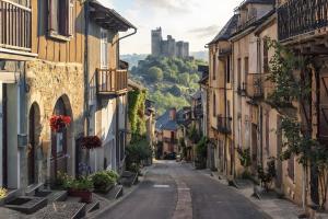 an empty street in an old town with a castle at Gite Belcastel -Village d’Exception in Belcastel