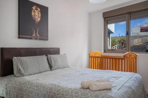 a bedroom with a bed with a lion picture on the wall at Ínsula Home in Tamaraceite