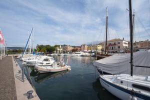 a group of boats are docked in a harbor at Appartamenti Dama 2 in Bardolino