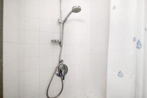 a shower with a shower head in a bathroom at Beroni su due livelli in Bonassola +12 photos