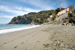 a beach with footprints in the sand next to the ocean at Beroni su due livelli in Bonassola