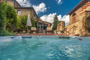 a large swimming pool in front of a house at Villa Assolata in Pietraviva