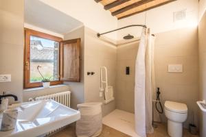 a bathroom with a sink and a toilet at Brotes Appartamento Castagno in Sovicille +25 photos