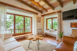 a living room with a couch and a table at Es Racó d'Alconàsser in Sóller