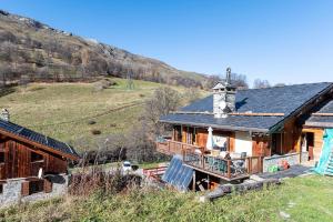 a log cabin with a mountain in the background at Chalet Les Menuires Val Thorens in Praranger