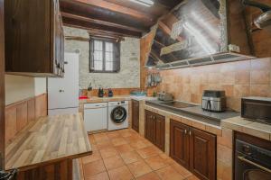 a kitchen with a sink and a dishwasher at La Morada del Cura in Calabazas