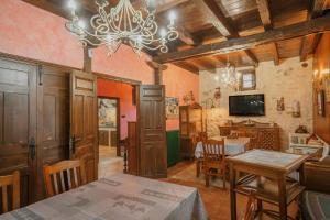 a dining room with a table and a chandelier at La Morada del Cura in Calabazas