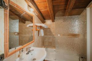 a bathroom with a sink and a mirror at La Morada del Cura in Calabazas +23 photos