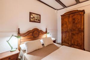 a bedroom with a bed with a wooden headboard at Casa Victor - Apartment 3 in La Orotava +12 photos